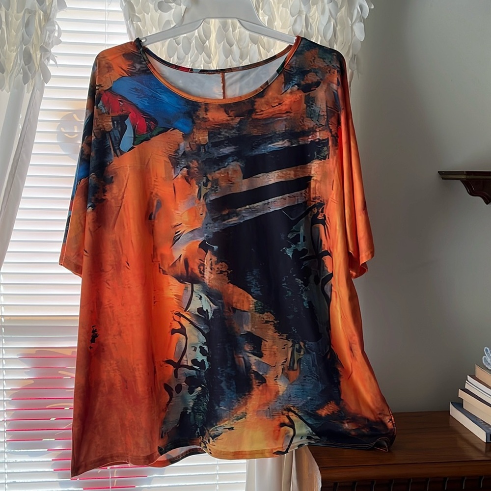 Orange and multicolored short sleeve top scoop neck size it say 4X.